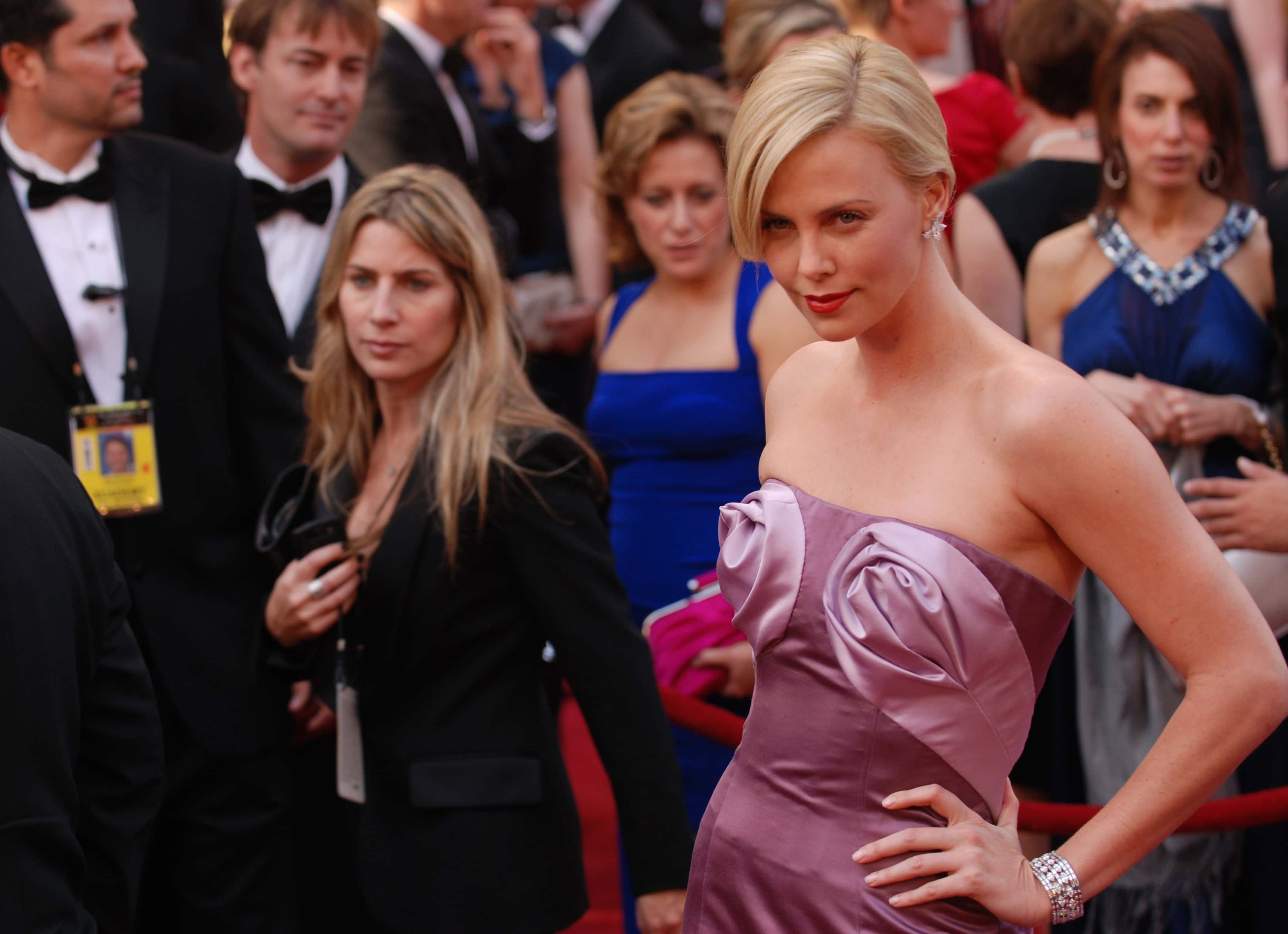 Charlize Theron at the 2010 Academy Awards, showcasing her elegant red carpet style as a symbol of her journey from Benoni to Hollywood stardom